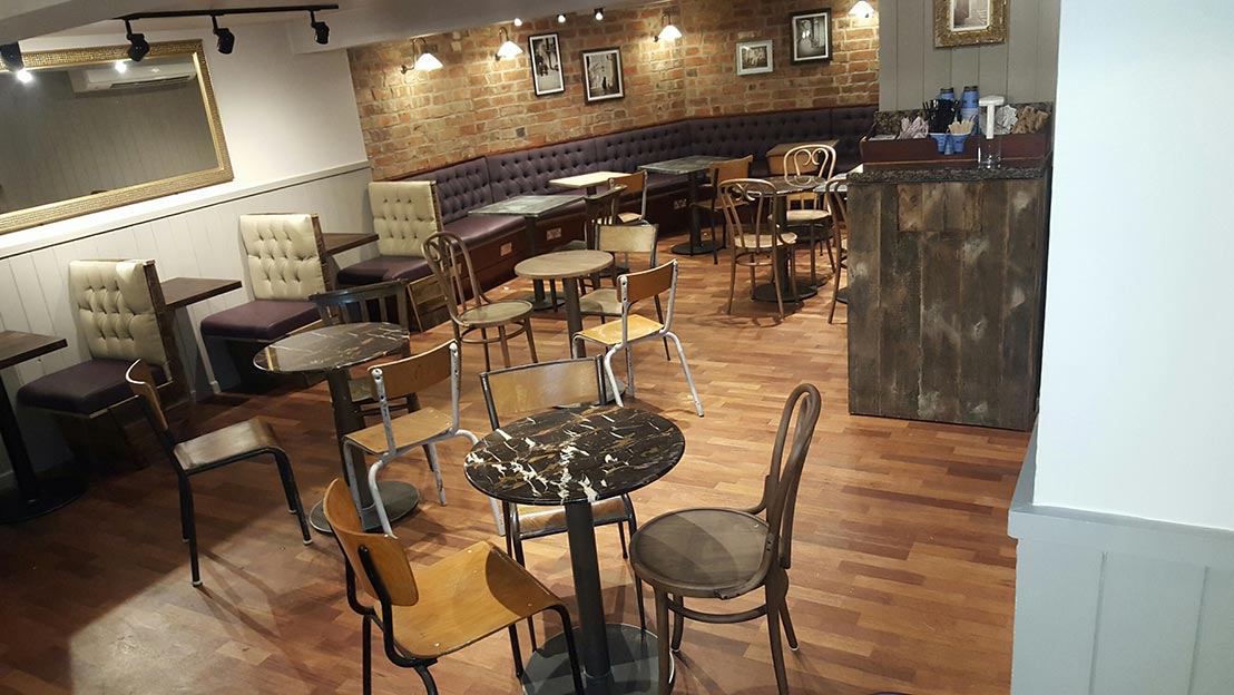 tables and chairs laid out in a refurbished cafe