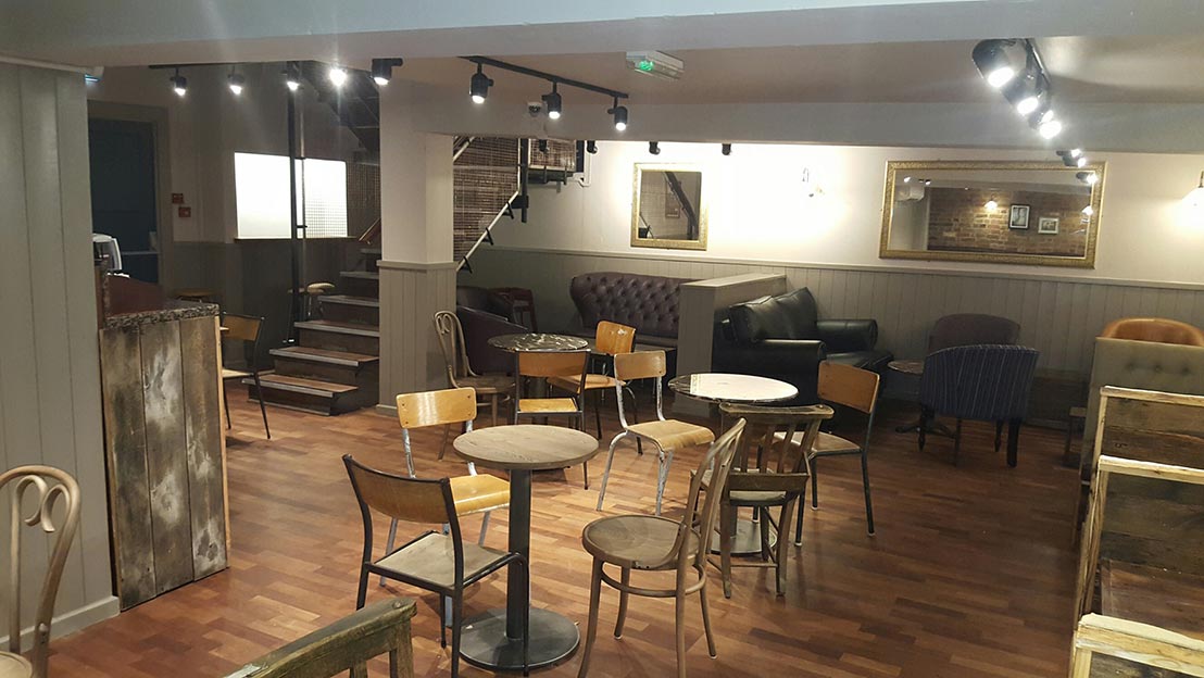 tables and chairs laid out in a refurbished cafe