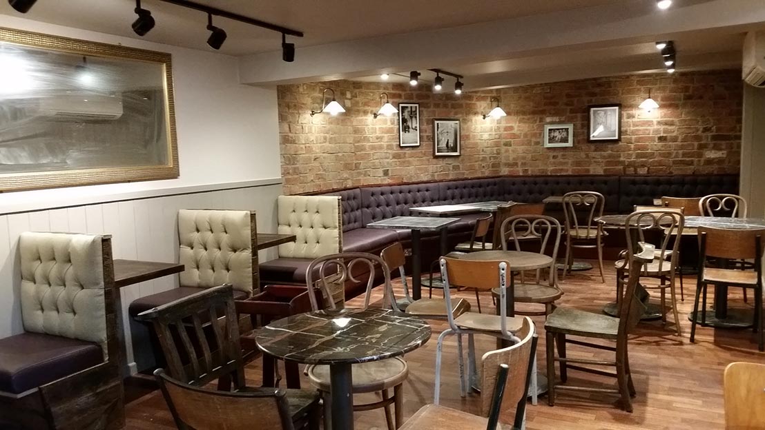 tables and chairs set out in a refurbished cafe